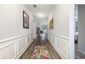 Elegant hallway with hardwood floors, decorative moldings, and stylish artwork displayed on the walls at 1377 Tessera Way, Myrtle Beach, SC 29579