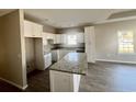 Modern kitchen with white cabinets, granite countertops and island at 150 Honeydew Rd., Myrtle Beach, SC 29588