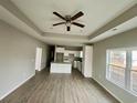 Open floor plan living room with kitchen island and view into kitchen at 150 Honeydew Rd., Myrtle Beach, SC 29588