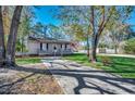 House with a driveway and mature trees in front at 1500 Docksider Ct., Surfside Beach, SC 29575