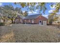 Expansive backyard with a lush lawn, mature trees, and access to the home's exterior at 1817 South Island Rd., Georgetown, SC 29440