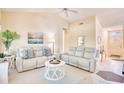 Bright, spacious living room with vaulted ceiling, white sofas, ceiling fan, and neutral carpet at 2110 Green Heron Dr., Murrells Inlet, SC 29576