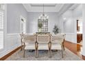 Formal dining room with coffered ceiling, decorative chandelier, and ample seating at 212 Minnow Ln., Murrells Inlet, SC 29576