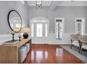 Bright foyer with hardwood floors, white trim, and a decorative glass front door at 212 Minnow Ln., Murrells Inlet, SC 29576