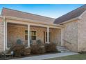 Inviting front porch with classic columns, seating, and well-maintained landscaping at 2531 Smiley Ln., Conway, SC 29526