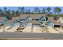 Overhead shot of townhomes featuring attached garages and craftsman style doors, with lush landscaping at 2539 Blue Crane Circle # 101, Myrtle Beach, SC 29577