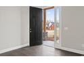 Open entryway with dark wood floors and a black front door leading to the porch at 270 Russ Rd., Loris, SC 29569