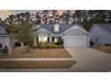 Charming single-story home with manicured lawn and attached two-car garage at 3713 Park Pointe Ave., Little River, SC 29566