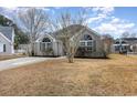 Charming single-story home with brick exterior, green shutters, and a well-manicured front yard at 3931 East Glades Dr., Myrtle Beach, SC 29588