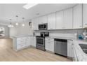 Modern kitchen with white shaker cabinets, granite countertops, and stainless steel appliances at 3983 Tybre Downs Circle # 3983, Little River, SC 29566