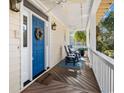 Inviting porch featuring rocking chairs and a blue door with decorative wreath at 438 Cayman Loop, Pawleys Island, SC 29585