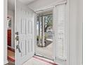 Bright entryway with a white door and storm door, offering a glimpse of the inviting exterior at 4396 Baldwin Ave. # 94, Little River, SC 29566