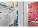 Functional laundry room with modern washer and dryer, wire shelving and convenient storage solutions at 4396 Baldwin Ave. # 94, Little River, SC 29566