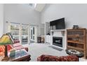 Spacious living room featuring a fireplace, TV, and access to the patio at 4396 Baldwin Ave. # 94, Little River, SC 29566