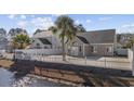 Nice backyard featuring a patio, white picket fence, and view of a waterway at 455 Blackberry Ln., Myrtle Beach, SC 29579