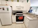 Well-lit kitchen with white cabinets, modern appliances, and attractive granite countertops at 4872 Dahila Ct. # 103, Myrtle Beach, SC 29577