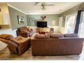 Inviting living room featuring brown leather seating, light green walls, and a sliding glass door at 4872 Dahila Ct. # 103, Myrtle Beach, SC 29577