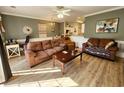 Spacious living room showcasing laminate floors, comfortable seating, and an adjoining dining area at 4872 Dahila Ct. # 103, Myrtle Beach, SC 29577