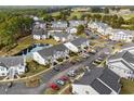 Aerial view of condominiums with mature trees and manicured grounds near a golf course at 4933 Crab Pond Ct. # 202, Myrtle Beach, SC 29579