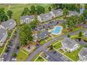 Aerial view of neighborhood condos near a pool, with mature trees and sidewalks throughout at 4933 Crab Pond Ct. # 202, Myrtle Beach, SC 29579