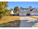 Front view of charming house with garage and landscaping at 516 5Th Ave. S, North Myrtle Beach, SC 29582