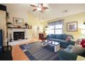 Open living room featuring a white-painted brick fireplace and hardwood floors at 604 Six Lakes Dr., Myrtle Beach, SC 29588