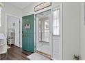 Bright foyer features decorative rug, coat closet and a storm door with natural light and rich flooring at 6208 Sweetwater Blvd. # 6208, Murrells Inlet, SC 29576