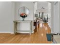 Welcoming foyer with hardwood floors and a decorative mirror creates an elegant entrance at 644 Serendipity Circle, Murrells Inlet, SC 29576