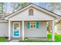 Charming single-story home features blue shutters, a covered porch, and a welcoming entrance at 6644 E Sweetbriar Trail, Myrtle Beach, SC 29588