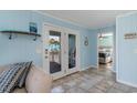 Bright entryway featuring tiled floors, doors to the porch, and bedroom access at 719 N Waccamaw Dr., Garden City Beach, SC 29576