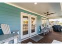 Spacious covered porch featuring furniture, ceiling fan, and room for entertaining at 719 N Waccamaw Dr., Garden City Beach, SC 29576