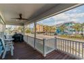 Relaxing covered porch with ceiling fan and scenic neighborhood views at 719 N Waccamaw Dr., Garden City Beach, SC 29576