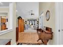 Inviting foyer with hardwood floors that flows into a living area with built-in shelving and natural light at 799 Helms Way, Conway, SC 29526