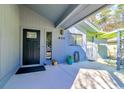 Inviting entryway with a stylish black door and a covered porch with outdoor decor at 908 Cedarwood Circle, Myrtle Beach, SC 29572