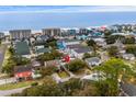 Aerial view of a neighborhood with houses near a stunning blue ocean coastline at 913 S Dogwood Dr. S, Surfside Beach, SC 29575