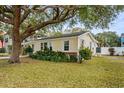 Side view of a charming yellow home featuring lush greenery and a well-maintained lawn at 913 S Dogwood Dr. S, Surfside Beach, SC 29575