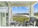 Balcony with chairs and a side table overlooking the marsh at 9400 Shore Dr. # 309, Myrtle Beach, SC 29572