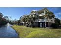 Exterior view of condo with palm trees and balconies overlooking a pond with a fountain at 1004 Ray Costin Way # 206, Murrells Inlet, SC 29576
