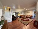Spacious living room featuring hardwood floors, comfortable seating, and a staircase at 11 S Beech Ave., Andrews, SC 29510