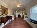 Bright and open living room with hardwood floors, a decorative mirror, and neutral paint at 11 S Beech Ave., Andrews, SC 29510