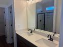 Bathroom featuring double sinks with dark cabinetry and black fixtures at 148 Joyce Dr, Longs, SC 29568