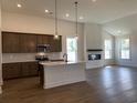 Spacious open kitchen featuring stainless steel appliances, wooden cabinets, and a central island at 148 Joyce Dr, Longs, SC 29568