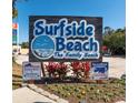 Surfside Beach sign proclaims, 'The Gathering Beach,' with colorful flowers in the landscape at 1510 S Ocean Blvd. # 101, Surfside Beach, SC 29575
