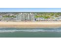 Picturesque aerial view of the beachfront condo with pristine sands and clear ocean waters at 1990 N Waccamaw Dr. # 401, Murrells Inlet, SC 29576
