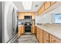Well-equipped kitchen with stainless steel appliances, light wood cabinets, and ocean views at 1990 N Waccamaw Dr. # 401, Murrells Inlet, SC 29576