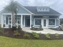 Beautiful model home with blue siding, manicured landscaping, and prominent Lennar signage at 2006 Lone Cypress Dr, Myrtle Beach, SC 29579