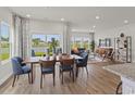 Inviting dining area with views of the water, seamlessly connected to the open living spaces at 2027 Copper Creek Loop, Longs, SC 29568