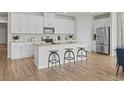 Stylish kitchen featuring stainless steel appliances, a granite island with barstool seating, and ample cabinetry at 2027 Copper Creek Loop, Longs, SC 29568