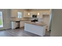 Bright, modern kitchen featuring white cabinetry, a center island, stainless steel appliances, and sleek countertops at 203 Wagner Cir., Conway, SC 29526