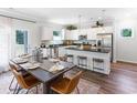 Beautiful kitchen with white cabinets, stainless steel appliances, a center island, and an adjacent dining area at 203 Wagner Cir., Conway, SC 29526